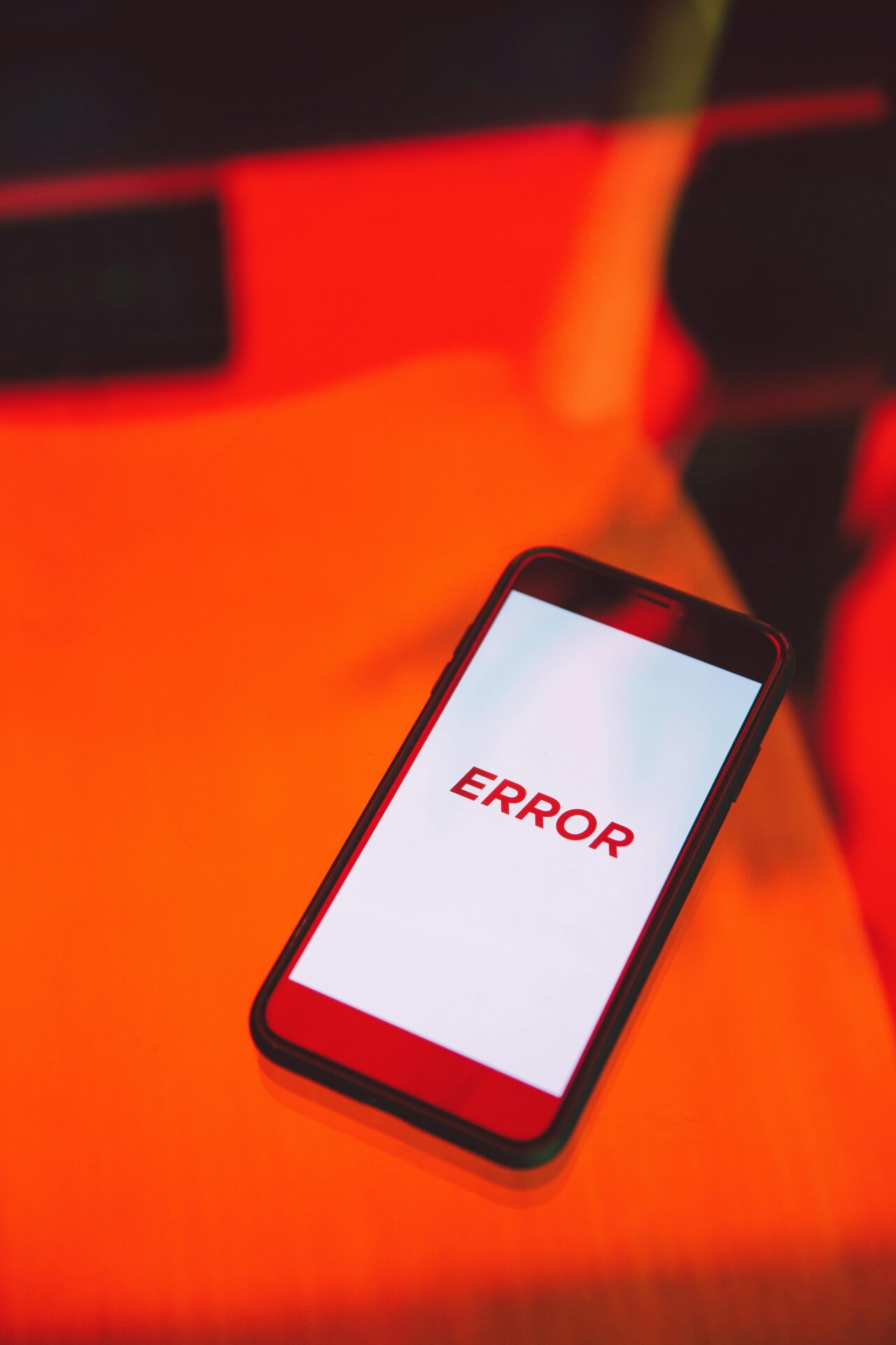Phone screen displaying the word ‘ERROR’ in red on a bright red background
